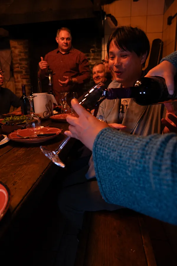 Guests raising glasses around the dinner table