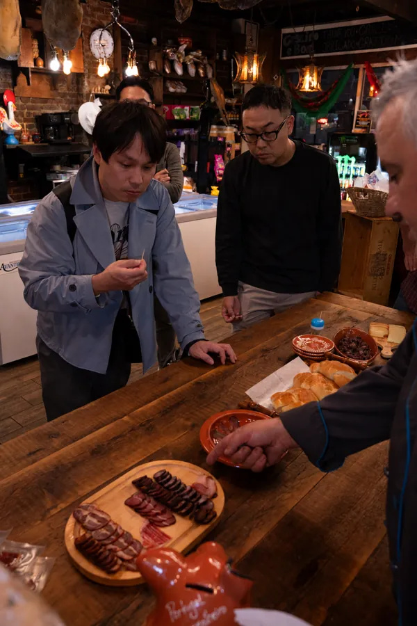Guests watching food being prepared at the wooden counter