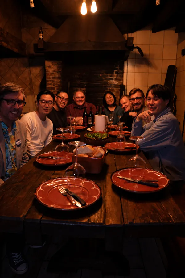 A group gathered around the Borralho dining table